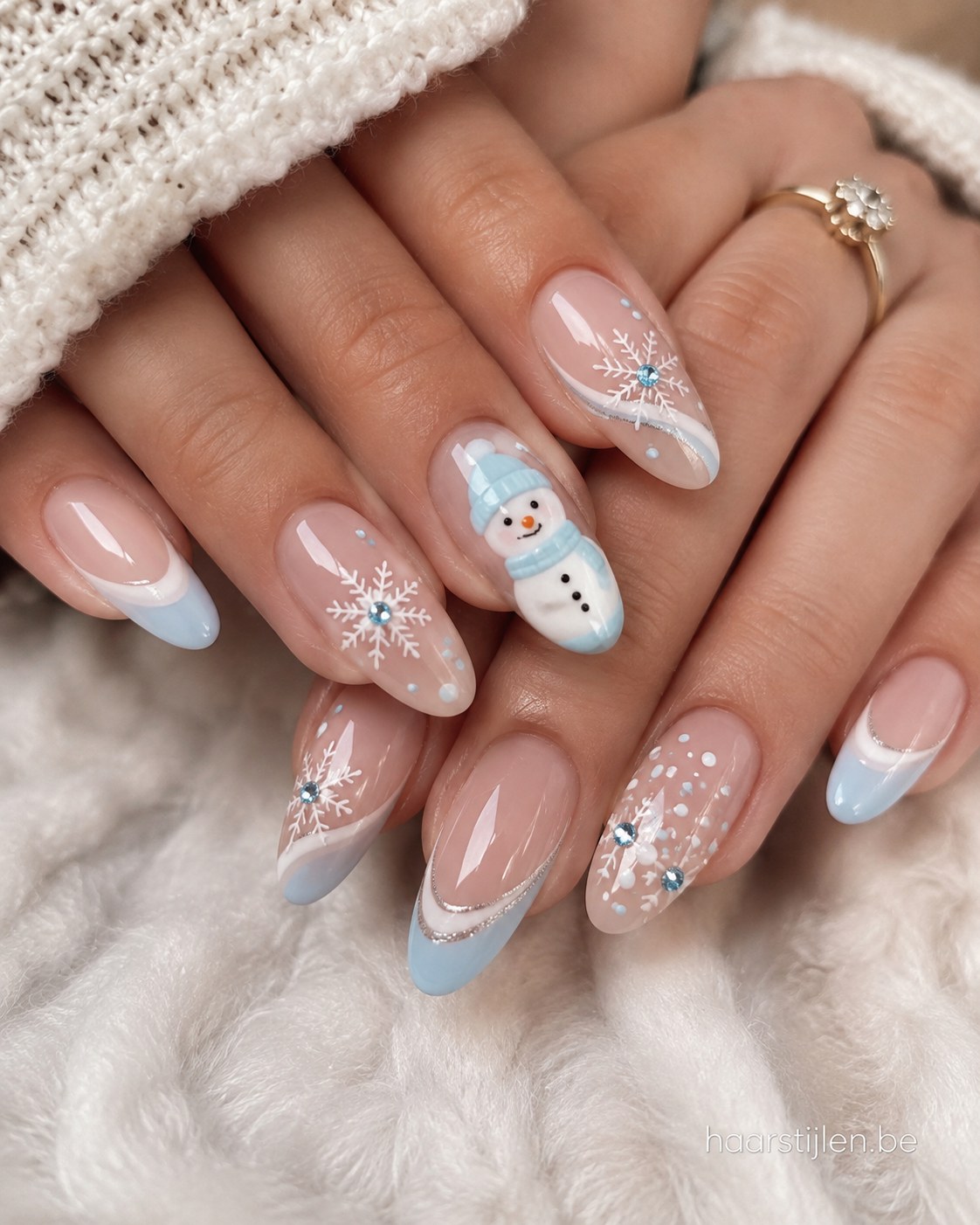 Lichtblauwe french kerstnagels met sneeuwpopje en steentjes als winters kerstnagels idee